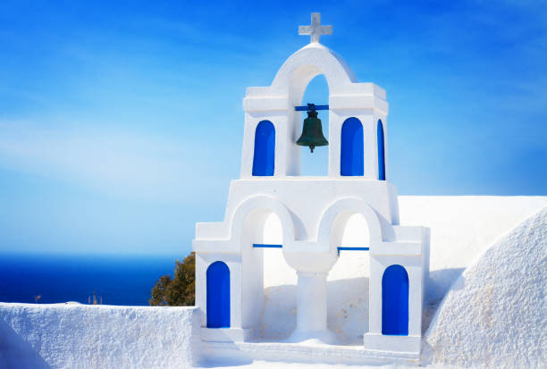 istock white with blue belfry, Santorini island, Greece 675383190