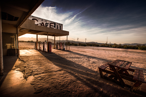 An abandoned cafe/gas station sits in the California desert.