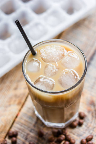 istock coffee break with cold iced latte and beans on wooden table background 675388746
