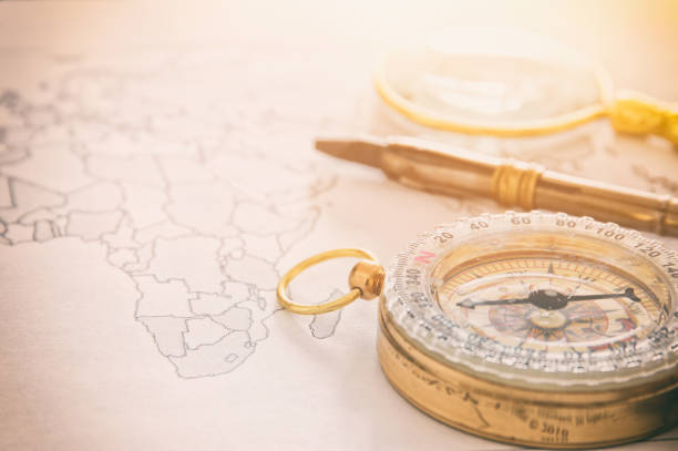 istock Image of map, magnifying glass and old compass 675392194