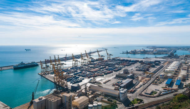 sunshine on balearic sea & barcelona industrial shipping and rail ports on a blue-sky day. - port de barcelona imagens e fotografias de stock