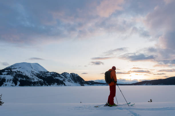 istock Skier with a stunning mountain sunset 675399856