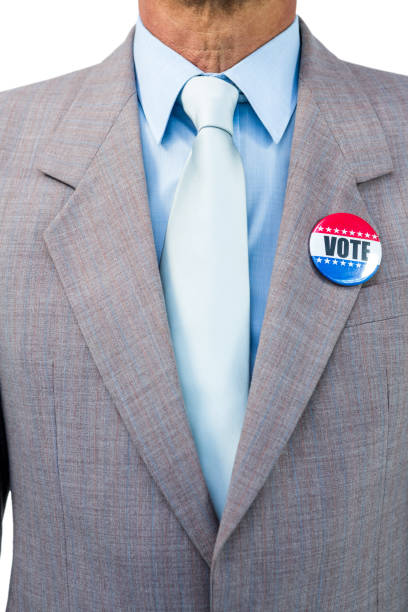 Businessman posing with badge on white background