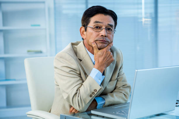 istock Thoughtful asian businessman looking at the camera 675416650