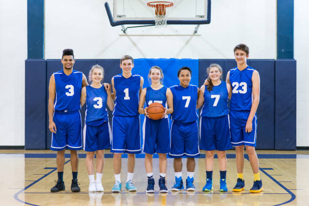 istock Mixed gender high school basketball team posing 675426214