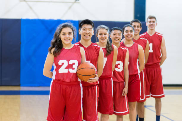 istock Mixed gender high school basketball team posing 675426218