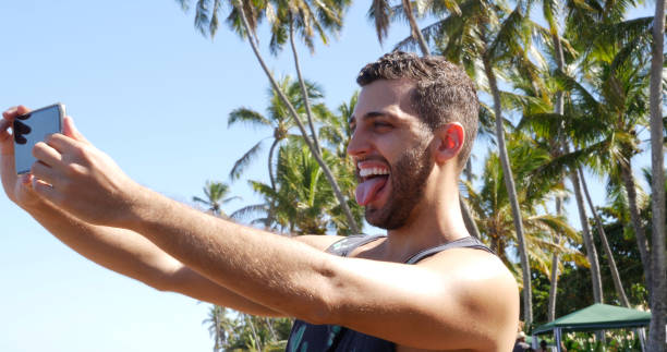 istock Man taking a selfie in a tropical beach 675426854