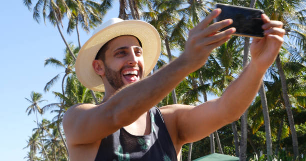 istock Man taking a selfie in a tropical beach 675426876