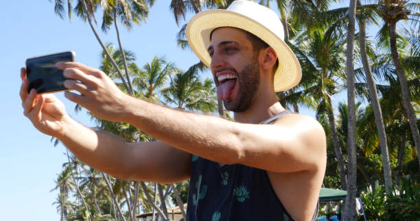 istock Man taking a selfie in a tropical beach 675426894
