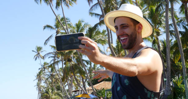 istock Man taking a selfie in a tropical beach 675426910