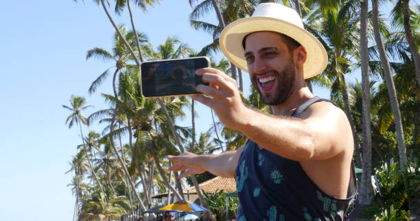 istock Man taking a selfie in a tropical beach 675426922