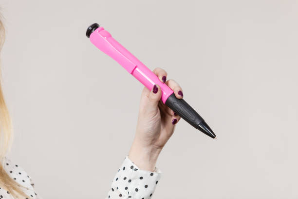 istock Woman holding big oversized pen 675433378