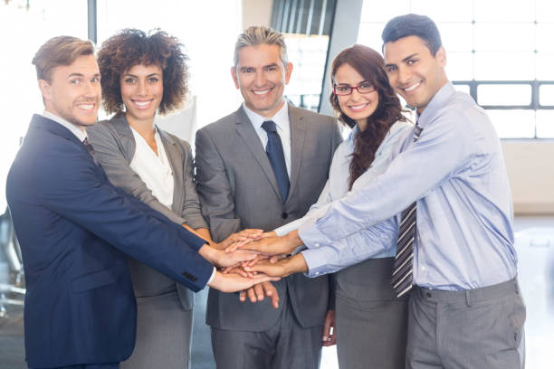 istock Businesspeople hands stacked over each other 675433604