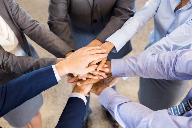 istock Close-up of Businesspeople stacking hands 675433814