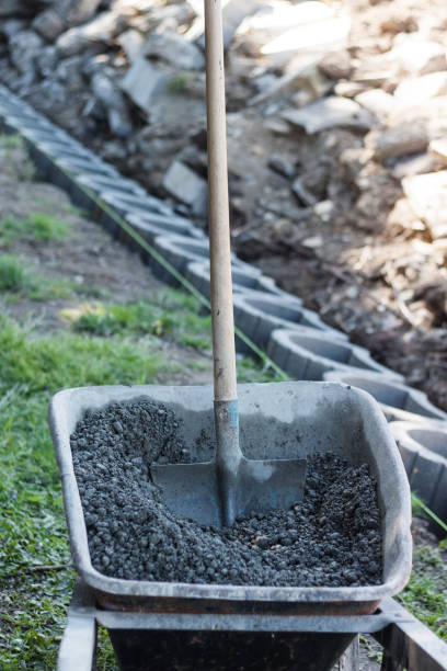 istock shovel stuck on concrete material on wheelbarrow 675439170