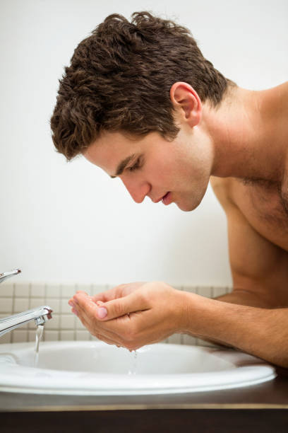 istock Man washing his face in the bathroom 675442944