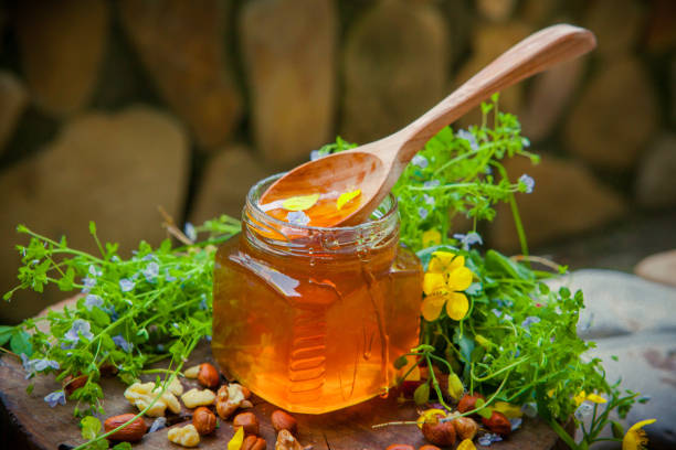istock Lime honey with a wooden spoon 675443006