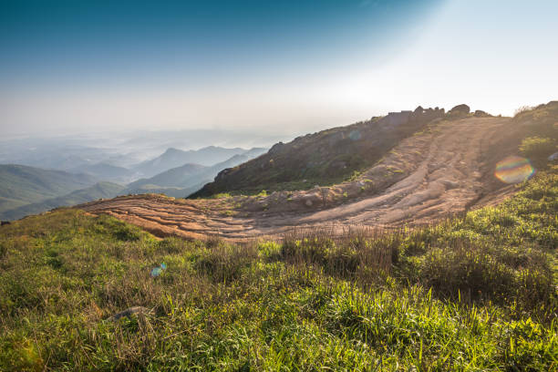 turn mud road in sunset with tire imprint for automobile commercial - mud dirt road road dirt imagens e fotografias de stock