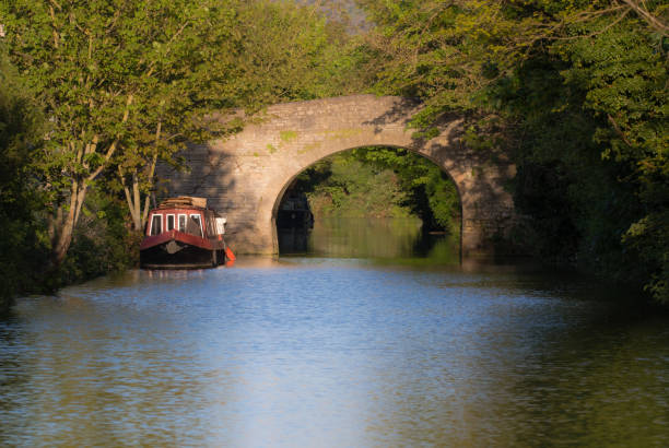 istock Narrow boats on River Avon with stone bridge 675445504