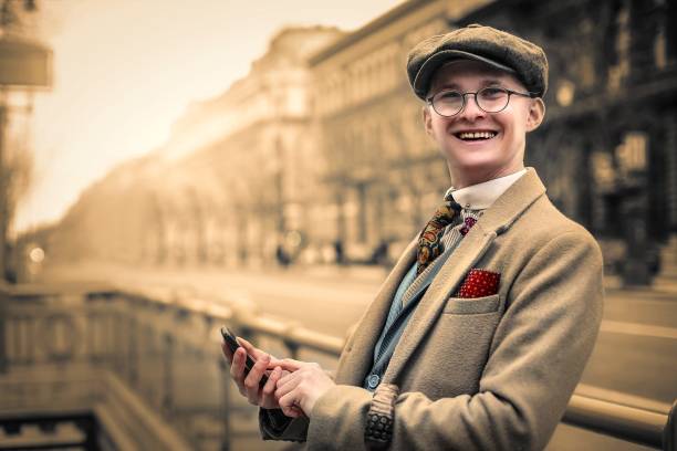 Stuck in 1930 Young man is typing on his mobile phone technology in the 1940s stock pictures, royalty-free photos & images