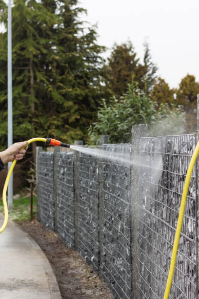 istock hand cleaning the stone wall with water 675448772
