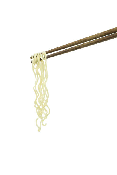 istock chopsticks holding oriental noodles isolated on a white background 675451294