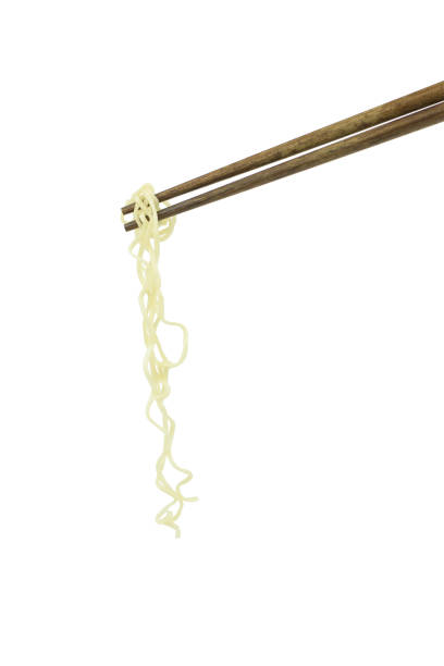 istock chopsticks holding oriental noodles isolated on a white background 675451340