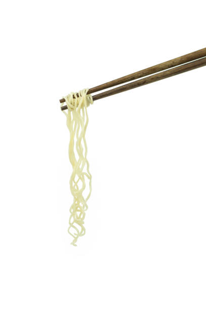 istock chopsticks holding oriental noodles isolated on a white background 675451364