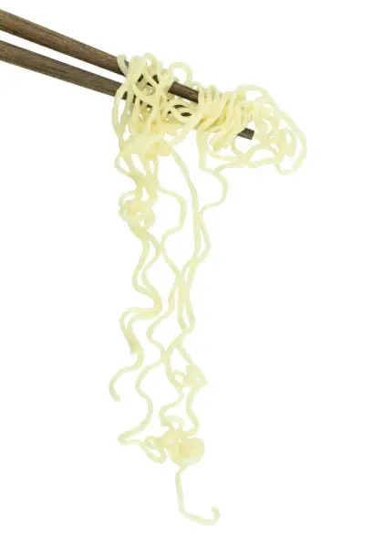 Photo of chopsticks holding oriental noodles isolated on a white background