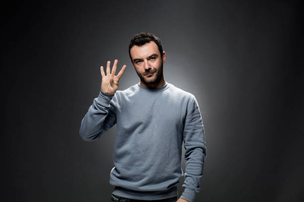istock Young Man Showing Number Four with Fingers. 675455552