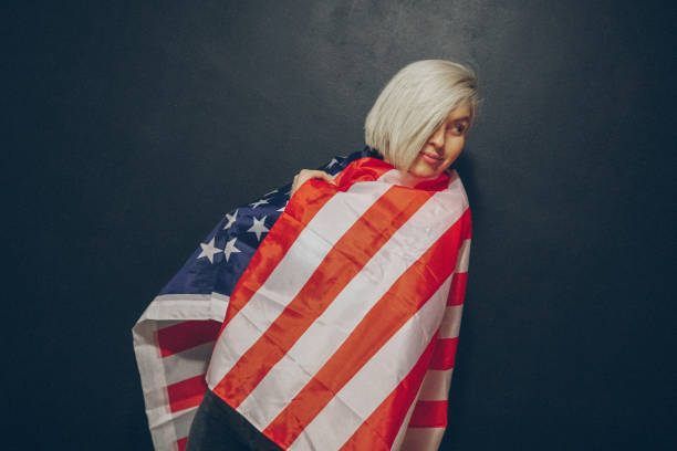 istock Blonde girl with USA flag 675458564