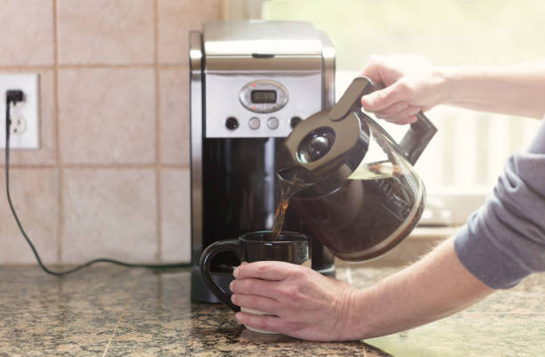 istock Pouring morning coffee with bright morning light from window 675458594