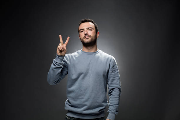 istock Young Man Showing Number Two with Fingers. 675458738