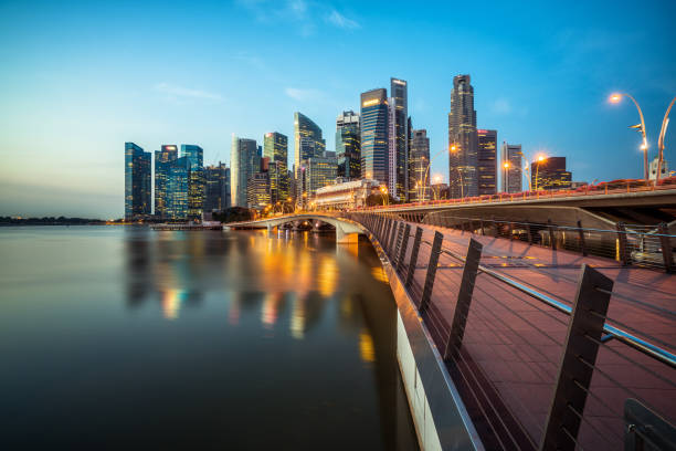 Singapore central business district skyline at blue hour Singapore skyline at night. Singapore central business district skyline, blue sky and night skyline from marina bay. Singapore cityscape. Marina bay, tourist destination and city center of Singapore. singapore cash stock pictures, royalty-free photos & images