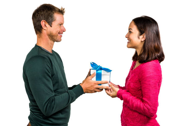 istock Smiling couple holding gift box 675461964
