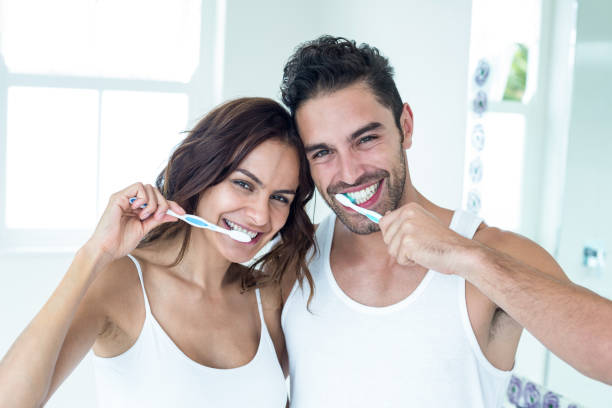 istock Happy couple brushing teeth in bathroom 675462192