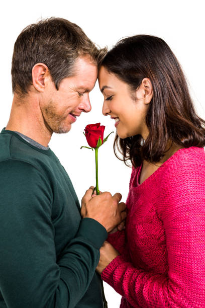istock Happy couple holding red rose 675462690