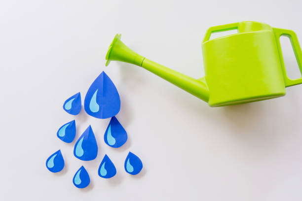 istock watering pot and and water droplets 675469590