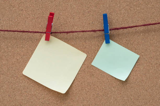istock Notepad and paper clip on the cork broad. 675472164