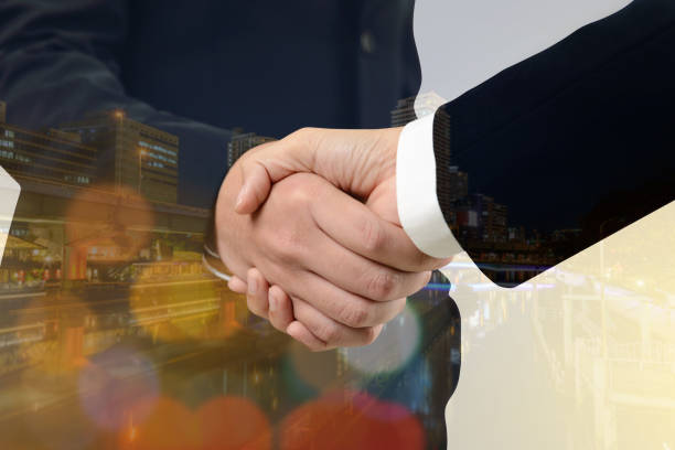 istock Double exposure of handshake between businessman with cityscape 675472970