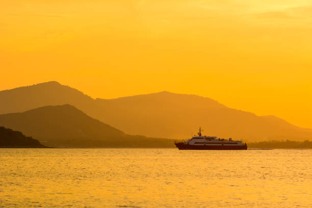 istock passenger boat with orange sunset 675481918
