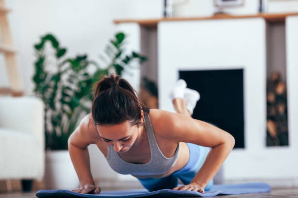istock women exercise indoor at home she is acted push-ups 675484480