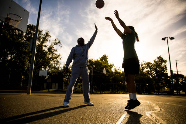 istock Father and Daughter Playing Basketball 675485282