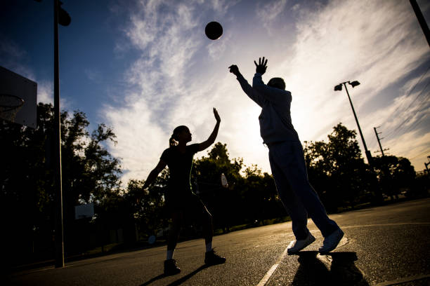 istock Father and Daughter Playing Basketball 675485348