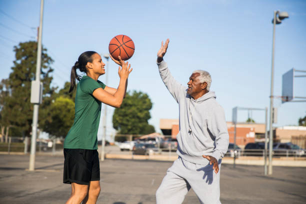 istock Father and Daughter Playing Basketball 675485364