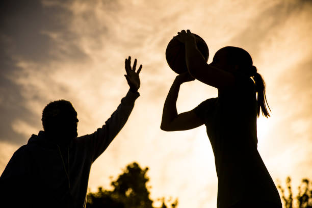 istock Father and Daughter Playing Basketball 675485390