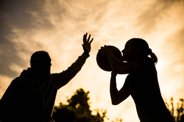 istock Father and Daughter Playing Basketball 675485434