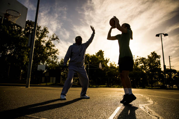 istock Father and Daughter Playing Basketball 675485468
