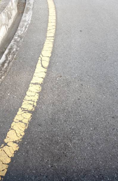 istock Asphalt texture background with faded yellow line 675485504