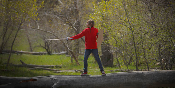 istock Boy playing pretend with sword and monster 675485672